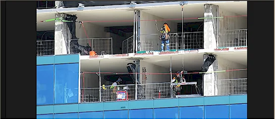 Construction crews working behind newly installed glass on the former Mirage hotel tower